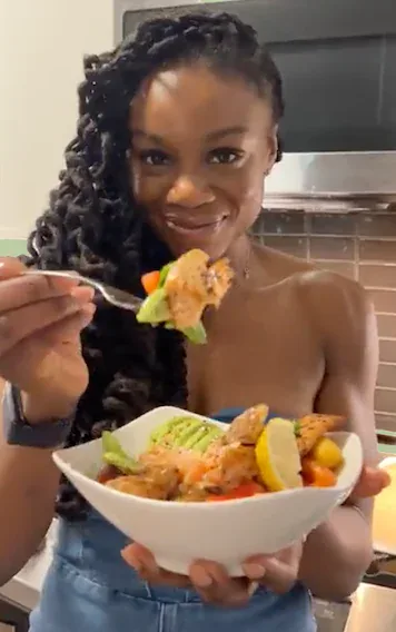 A happy Hungryroot customer eating a homemade meal