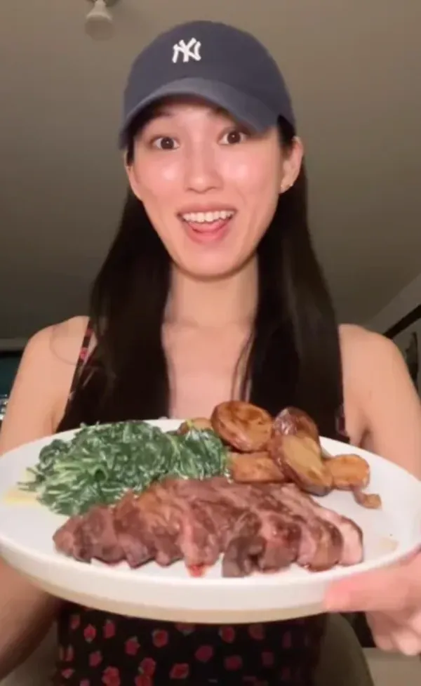 A happy Hungryroot customer eating a homemade meal