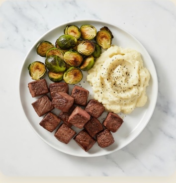 Steak bites with mashed potatoes and brussels sprouts
