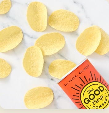 The Good Crisp Company chips scattered on marble