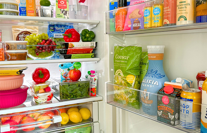 Well-stocked refrigerator with fresh groceries