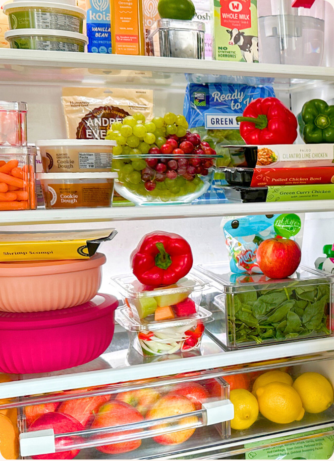 Well-stocked refrigerator with fresh groceries