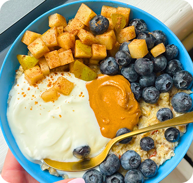 Orange curry bowl with rice and herbs